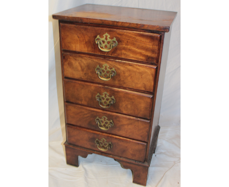 A small Georgian-style mahogany chest of five short drawers with brass ring handles on bracket feet, 27" high x 15½" wide