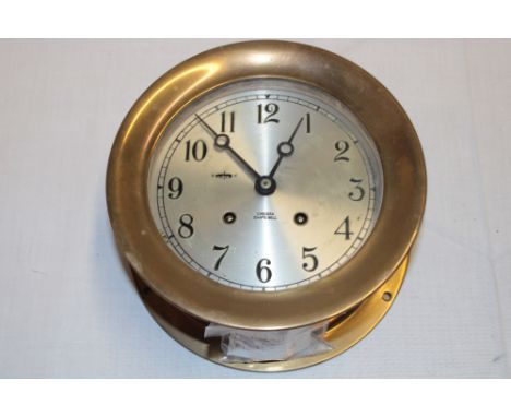 A good quality brass ship's clock with silvered circular dial marked "Chelsea Ship's Bell" with movement chiming the ship's w