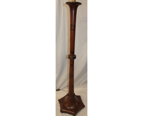 An Eastern lacquered wood standard lamp decorated with Chinese figures and emblems on hexagonal base