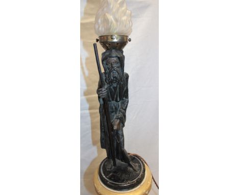 An unusual table lamp/floor lamp, the painted metal stem modelled as an elderly traveller on painted pedestal base with opaqu