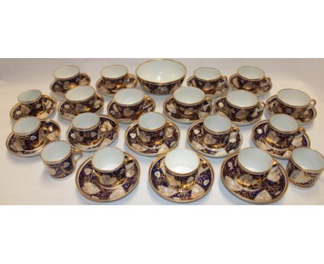 An early 19th century Worcester china part tea and coffee set comprising nine tea cups with blue and gilt heart-shaped decora