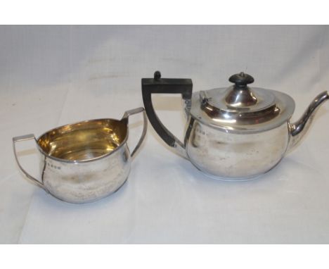 A George V Scottish silver oval tea pot with ebonised handle and hinged lid, Glasgow marks 1923 together with a matching Glas