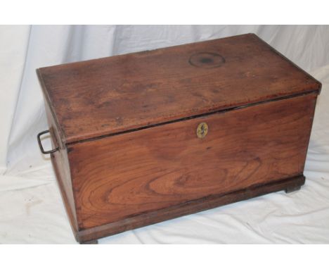 A late 18th/early 19th century elm rectangular trunk with hinged lid and iron handles, 29" long