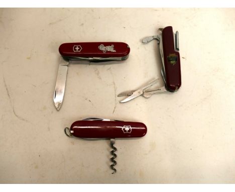 Three Swiss Army penknives, one with vintage motorcar/automobile emblem  This bladed lot is not for sale to people under the 