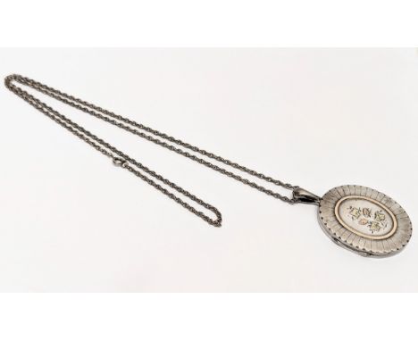 An early 20th century silver locket &amp; chain, stamped Chester MG &amp; Co. 40.5 grams. Locket measures 4x5.5cm. Chain 38cm