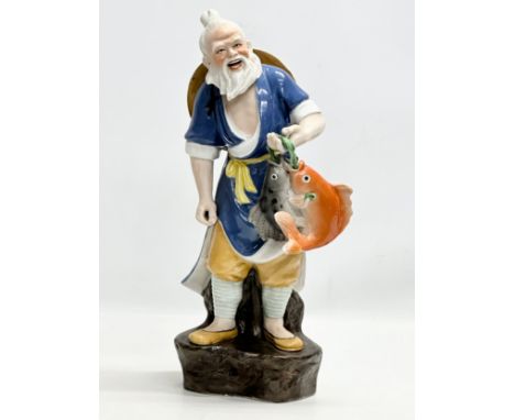 A large Chinese fisherman statue. Impressed marks. 42cm