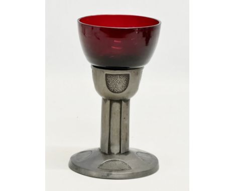 An Early 20th Century Art Nouveau pewter cup with inserted ruby glass bowl. 15cm