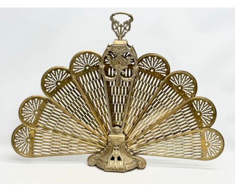 A vintage brass peacock firescreen.