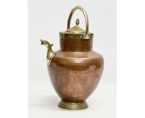 An Early 20th Century Italian copper and brass water pitcher. 22x17x32cm