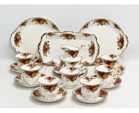 A 21 piece Royal Albert “Old Country Roses” tea service. 2 cake plates, sandwich tray, 3 sandwich plates, milk jug, sugar bow