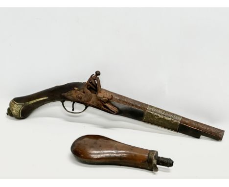 A 19th Century Turkish percussion cap pistol and a British gunpowder flask. 44cm