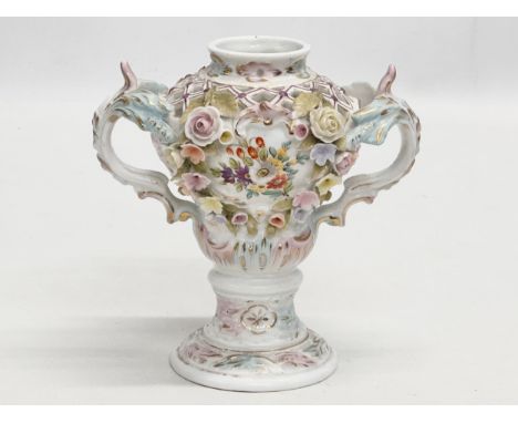 Sitzendorf. A Late 19th Century hand painted and pierced porcelain urn shaped vase, with foliage flowers and handles. By Sitz