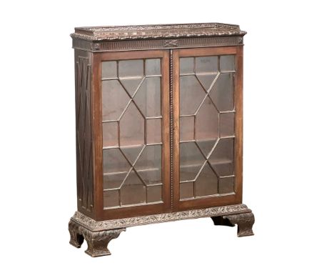 An early 20th century Chippendale Revival mahogany bookcase with astragal doors and carved Ogee Feet. Circa 1900. 113x37x135c