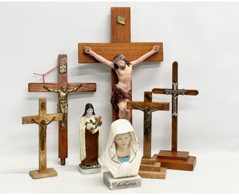 A quantity of Early 20th Century tabletop and wall hanging crucifix’s. With later Madonna figures. Pitch pine and plaster wal