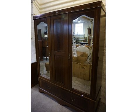 An Edwardian Mahogany Wardrobe, Having two mirrored doors enclosing hanging space, above two small drawers, 199cm high, 150cm