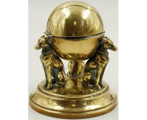 A VICTORIAN BRASS INKWELL IN THE FORM OF 3 DOGS SUPPORTING A GLOBE. WEIGHING JUST OVER 500gms AND STANDING 12cms TALL 