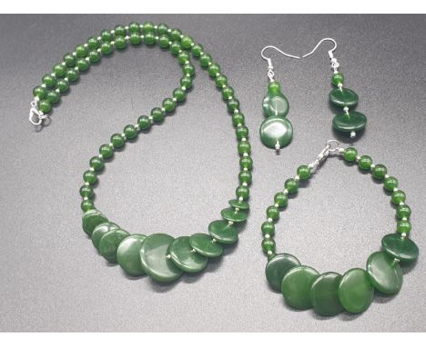 A modern spinach green jade necklace, bracelet and earrings set in a presentation box. Necklace length: 51cm, bracelet length