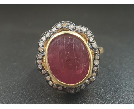 A 10cts Ruby gemstone ring with a halo of rose cut diamonds in pave setting vintage style. Size N/O 