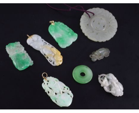 Seven Chinese jadeite pendant carvings and a jade circular dish, 19th / 20th century, the largest 5cm