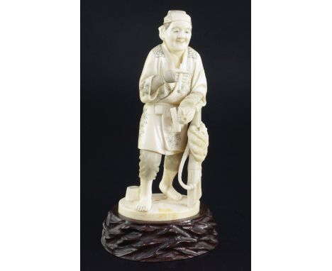 A Japanese ivory figure of a farmer holding his pipe, signed Gyozan, early 20th century, standing and leaning on his basket c