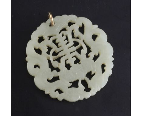 A Chinese pale celadon and jade circular plaque, 19th century, carved and pierced with a bat and a shou character flanked by 