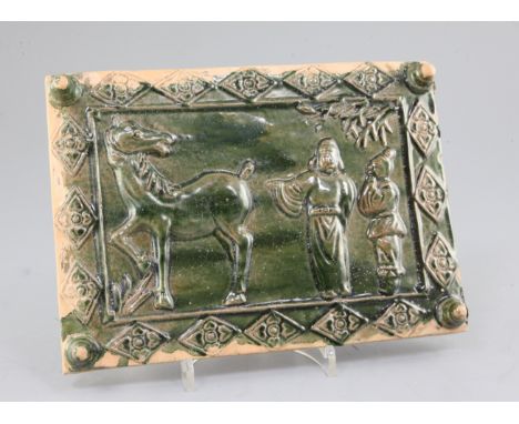 A Chinese green glazed pottery rectangular tile, moulded in relief with a Chinese scholar, attendant and horse, 27 x 19.5cm