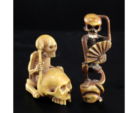 Two Japanese ivory okimono / netsuke of skeletons, 19th century, the first of a skeleton seated before a larger skull holding