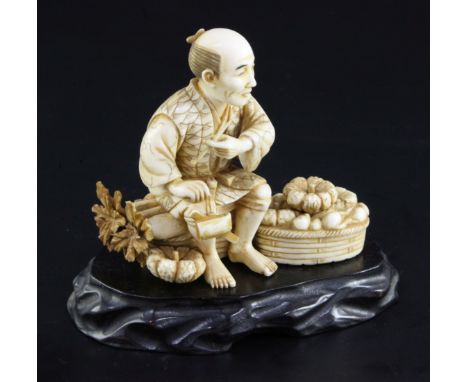 A Japanese ivory okimono of a farmer smoking a pipe, early 20th century, seated amid his crop of vegetables, engraved two cha