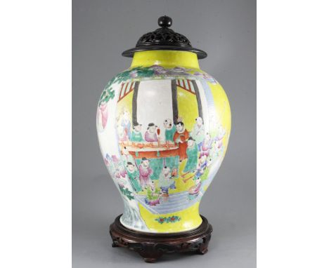 A Chinese yellow ground 'Hundred Boys' jar, 19th century, painted with boys celebrating a festival including holding aloft mo
