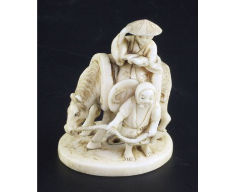 A Japanese ivory okimono netsuke, signed Gyokuzan, Meiji period, carved as a man on horseback with a woman holding the horses