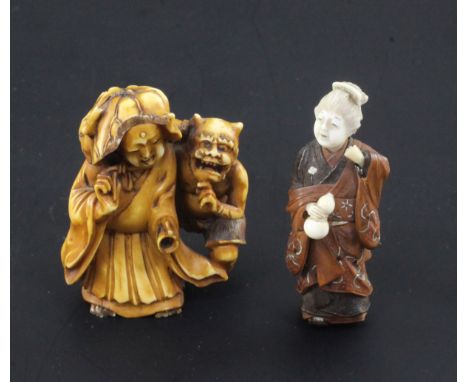 Two small Japanese okimono, 19th / early 20th century, the first in stained ivory carved as a lady being surprised by an oni,