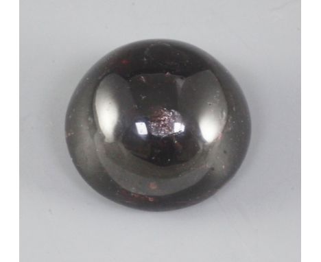 A Chinese red gem stone cabochon shaped scroll weight, diameter 5.1cm