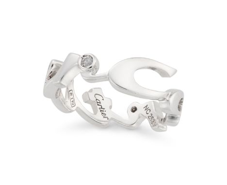 CARTIER, A DIAMOND SIGNATURE RING in 18ct white gold, designed as the signature 'Cartier', set with round brilliant cut diamo