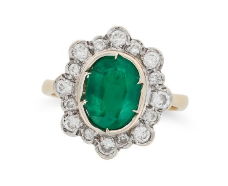 AN EMERALD AND DIAMOND CLUSTER RING in 18ct yellow gold, set with an oval cut emerald of approximately 1.90 carats in a clust