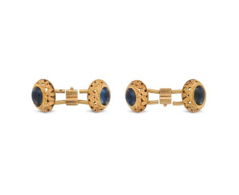 A PAIR OF VINTAGE SAPPHIRE CUFFLINKS in yellow gold, each set with an oval cabochon sapphire in a foliate style border, no as