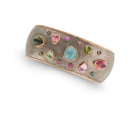 A MULTICOLOUR TOURMALINE CUFF BANGLE the open cuff bangle set with cabochon and round cut blue, pink and green tourmalines, t