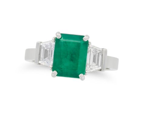 AN EMERALD AND DIAMOND THREE STONE RING in platinum, set with an octagonal step cut emerald of 2.32 carats, accented on each 