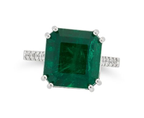 A COLOMBIAN EMERALD AND DIAMOND RING set with an octagonal step cut emerald of approximately 7.00 carats, the band set with r