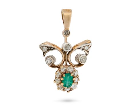 AN ANTIQUE EMERALD AND DIAMOND PENDANT in yellow gold, the scrolling pendant set with an oval cut emerald in a cluster of old