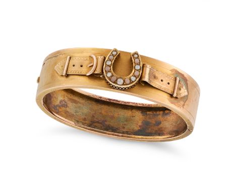 AN ANTIQUE PEARL AND CORAL HORSESHOE BANGLE in yellow gold, the hinged bangle with a horse shoe motif set with alternating pe