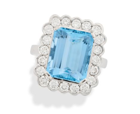 AN AQUAMARINE AND DIAMOND CLUSTER RING in 18ct white gold, set with an octagonal step cut aquamarine of approximately 6.37 ca