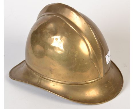 A early 20th century German Bavarian brass fireman`s helmet with its original leather liner marked `Geber Ohliger Kaiserslaut
