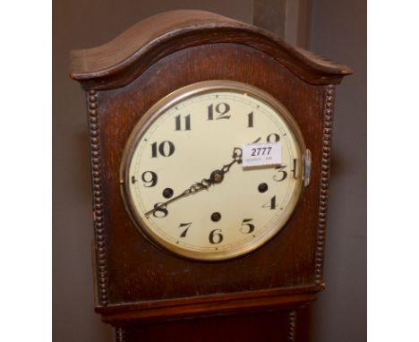 A 1930's oak eight day grandmother clock.