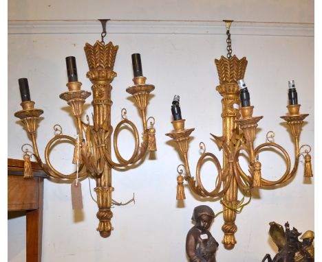 A pair of gilt Neoclassical triple branch wall lights of quiver and arrow form with hanging tassels, height 63cm.