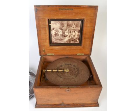 An 11" table top Polyphon with marquetry and walnut veneered case together with 15 discs.