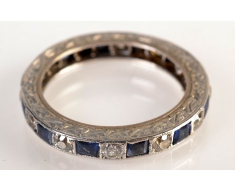 A sapphire and diamond eternity ring. Condition Report: Good condition size L/K, several stones with chips and scratches