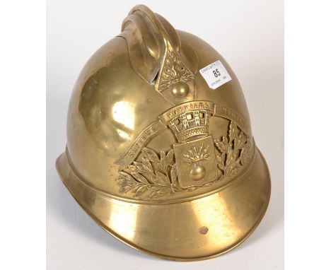 An early 20th century French Sapeurs Pompiers Cte. U De Lyon brass fireman`s helmet with its original leather liner. 

