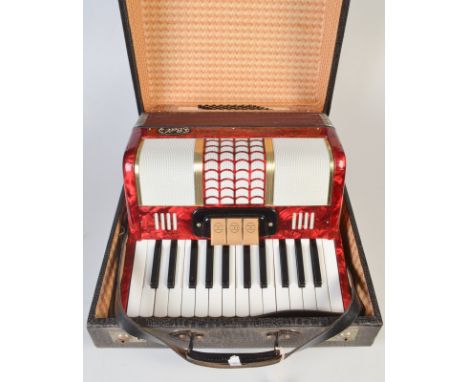 A Bell red pearlescent piano accordion, hard case.