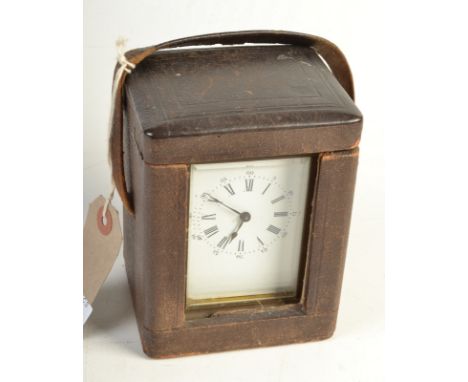 An early 20th century, brass carriage clock, in a black leather case.