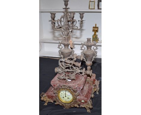 A continental red marble and spelter candelabra clock garniture.